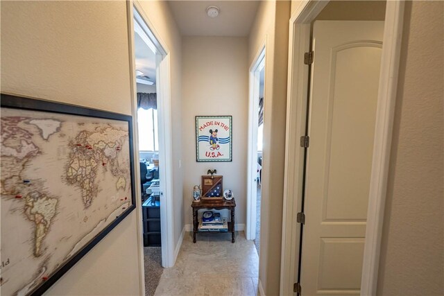 corridor featuring baseboards