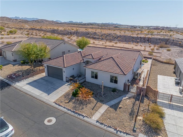 view from above of property with a mountainous background and a desert landscape