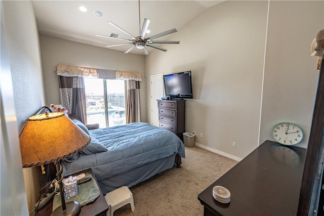 carpeted bedroom with vaulted ceiling, baseboards, and ceiling fan