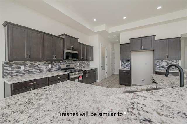6175 S Los Lagos Bay Bay, Fort Mohave, AZ 86426 - kitchen with appliances with stainless steel finishes, light stone counters, light wood-type flooring, a sink, and recessed lighting
