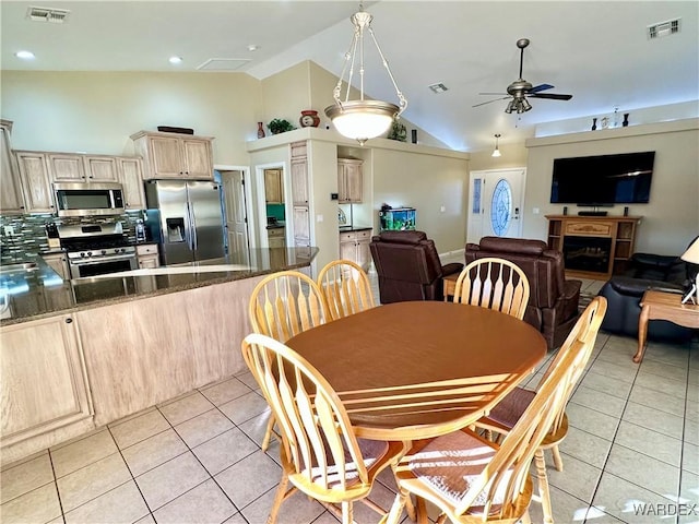 dining area featuring ceiling fan, light tile patterned flooring, and visible vents