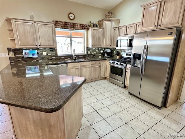 kitchen with tasteful backsplash, a peninsula, stainless steel appliances, open shelves, and a sink