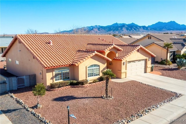 view of front of property featuring a tile roof, a mountain view, and stucco siding