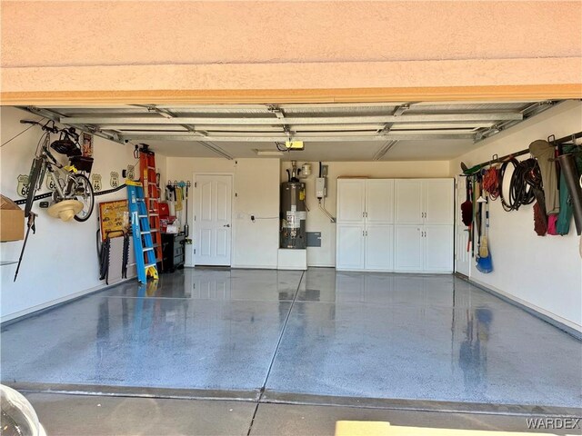 garage featuring gas water heater and a garage door opener