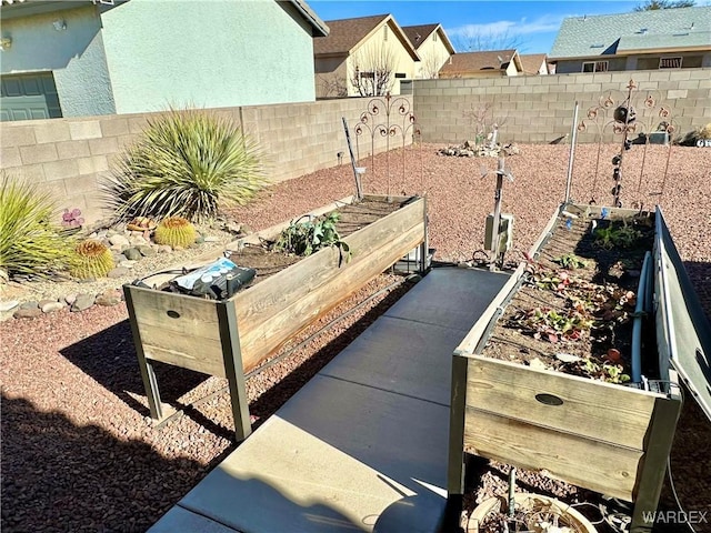 exterior details featuring fence private yard and a vegetable garden