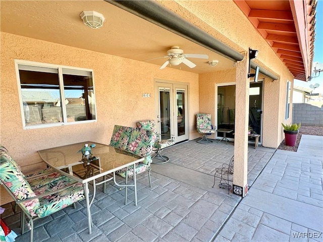 view of patio featuring fence and a ceiling fan