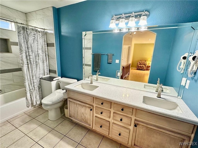 full bathroom featuring a sink, shower / bathtub combination with curtain, and double vanity