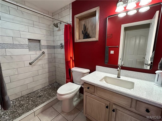 bathroom featuring a stall shower, vanity, toilet, and tile patterned floors