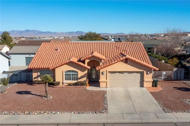 view of front of property featuring a mountain view, a tiled roof, and stucco siding