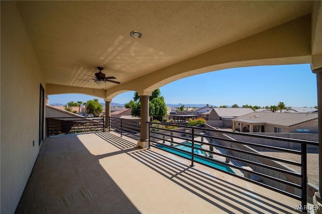 view of patio with a balcony, a residential view, and a ceiling fan