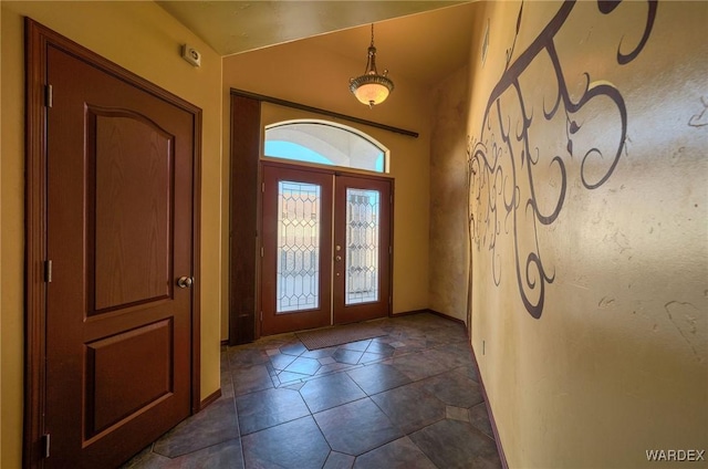 entrance foyer with french doors and dark tile patterned floors