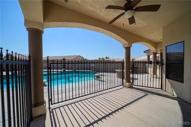 view of patio / terrace featuring a fenced in pool, fence, and a ceiling fan