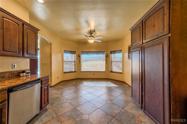 kitchen with a ceiling fan, baseboards, arched walkways, and dishwasher