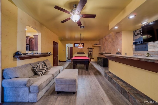 recreation room featuring arched walkways, pool table, visible vents, a ceiling fan, and wood finished floors