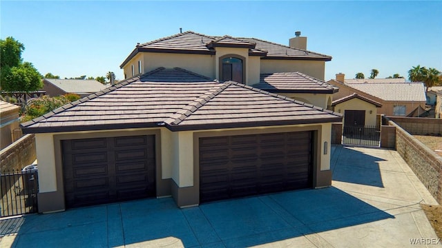 view of front of home featuring concrete driveway and fence