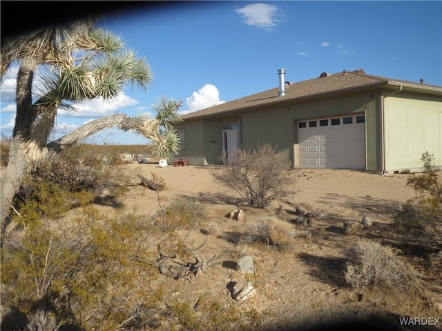 view of side of home with a garage