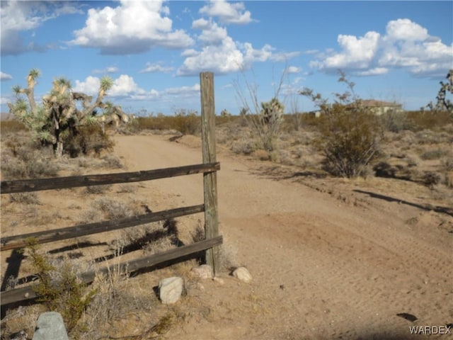 view of yard with a rural view and fence