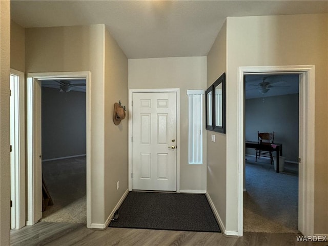 entrance foyer with ceiling fan, wood finished floors, and baseboards