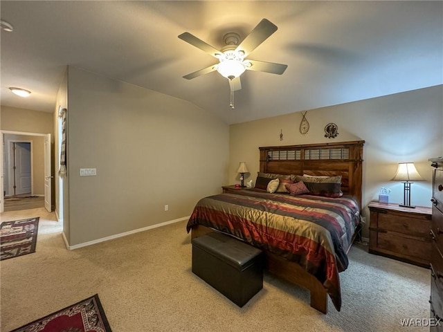 bedroom with lofted ceiling, baseboards, a ceiling fan, and light colored carpet