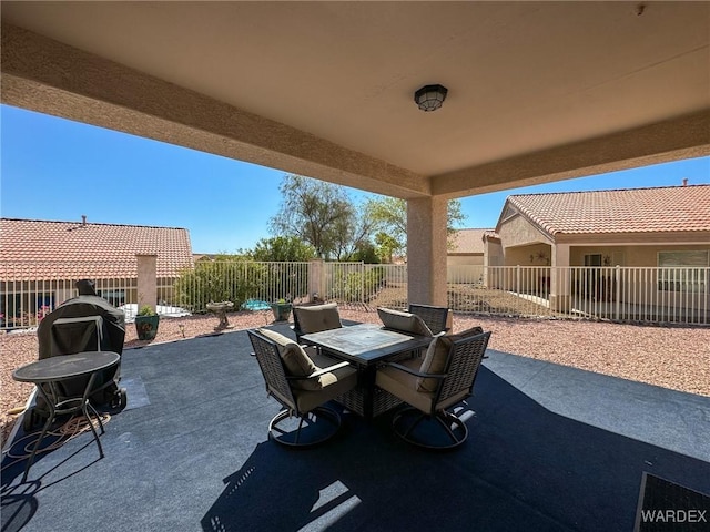 view of patio with outdoor dining area and a fenced backyard