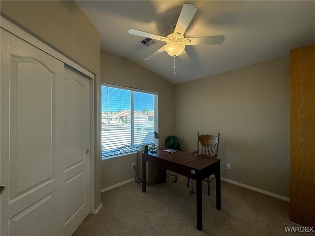 office space with vaulted ceiling, a ceiling fan, visible vents, and light colored carpet