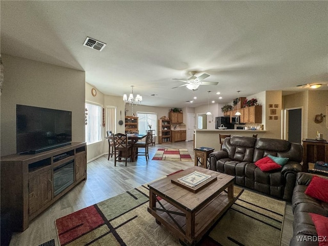 3020 Siena Dr, Bullhead City, AZ 86442 - living area with ceiling fan with notable chandelier, visible vents, and light wood-style floors