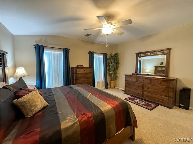 bedroom featuring lofted ceiling, light colored carpet, visible vents, ceiling fan, and baseboards