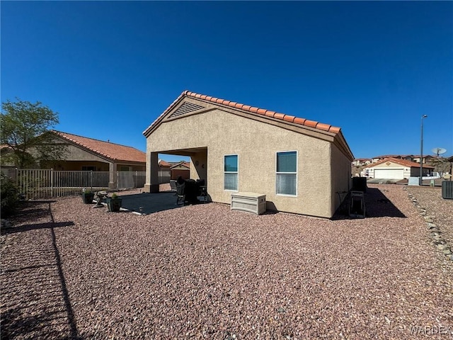 3020 Siena Dr, Bullhead City, AZ 86442 - rear view of property with a patio area, fence, a tiled roof, and stucco siding