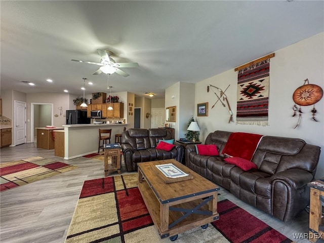 living area featuring recessed lighting, a ceiling fan, and light wood-style floors