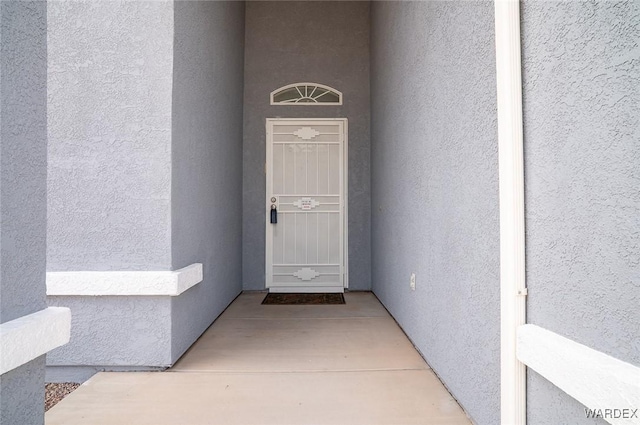 view of exterior entry with stucco siding