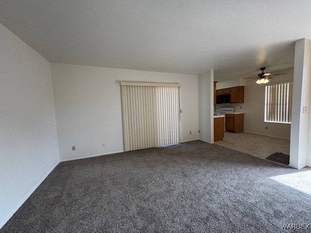 1280 Mohave Dr Unit 8A, Bullhead City, AZ 86442 - unfurnished living room featuring light colored carpet, baseboards, and a ceiling fan