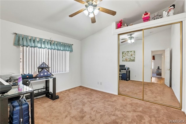 carpeted home office with lofted ceiling, ceiling fan, and baseboards