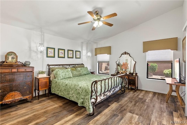 bedroom featuring vaulted ceiling, dark wood-style flooring, and a ceiling fan