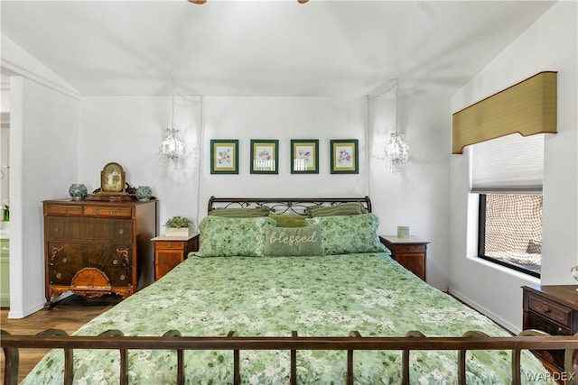 bedroom with dark wood-style flooring and baseboards