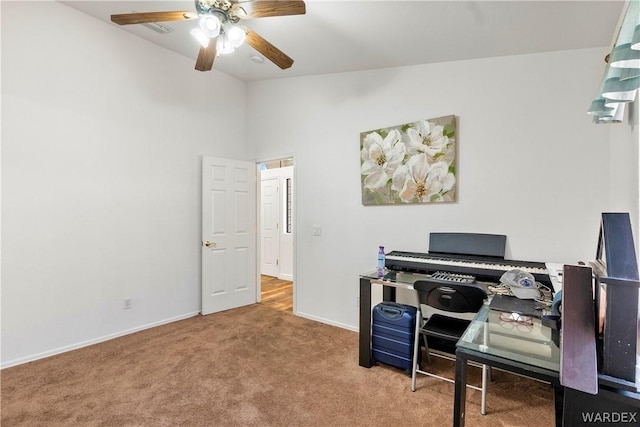 office space featuring carpet, a ceiling fan, and baseboards