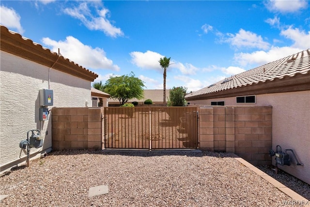 view of yard featuring fence and a gate