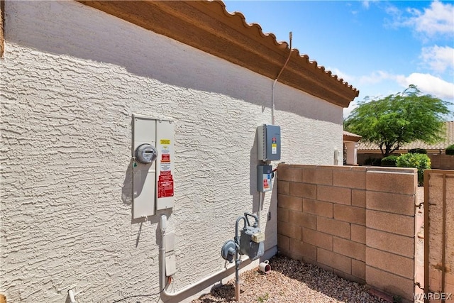 exterior space featuring gas meter and stucco siding