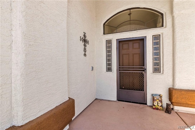 entrance to property featuring stucco siding