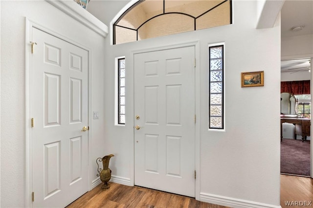 foyer entrance featuring light wood-style flooring and baseboards