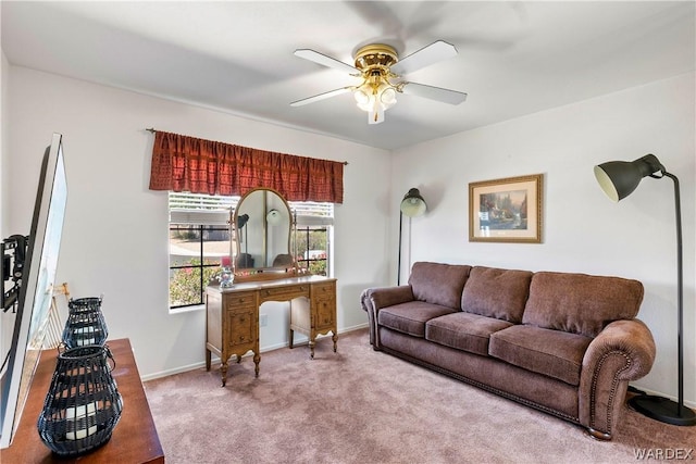 living area with light carpet, ceiling fan, and baseboards