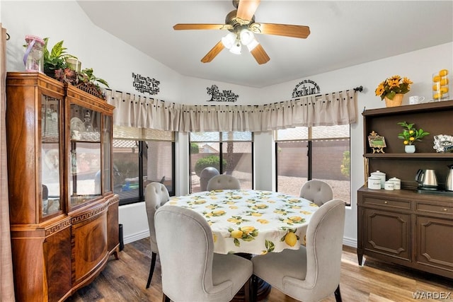 dining space with light wood finished floors, ceiling fan, and baseboards