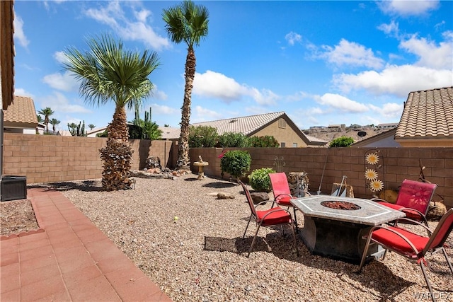 view of yard featuring an outdoor fire pit, a patio area, and a fenced backyard