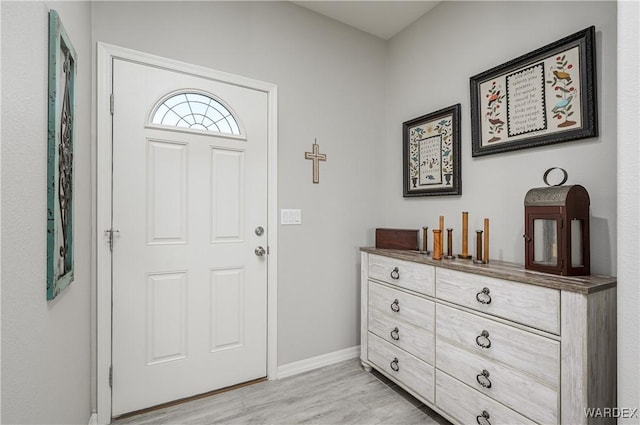 entrance foyer with light wood-style flooring and baseboards