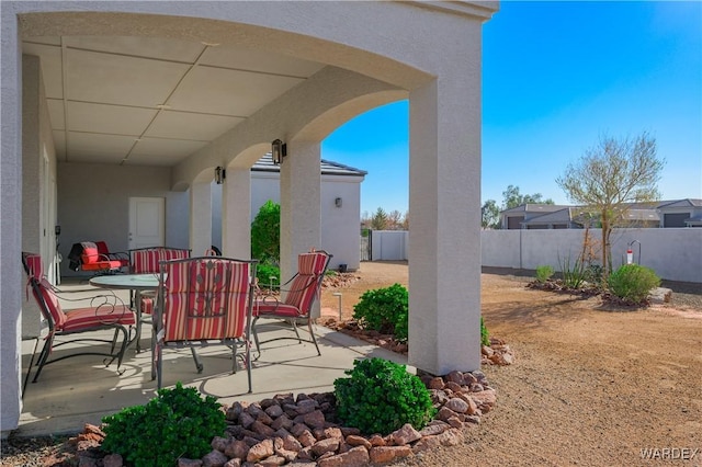 view of patio / terrace featuring outdoor dining space and fence