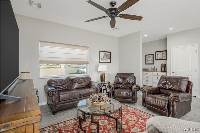 living room with ceiling fan, recessed lighting, visible vents, baseboards, and light wood-type flooring