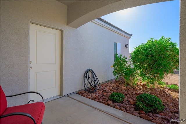 view of exterior entry featuring stucco siding