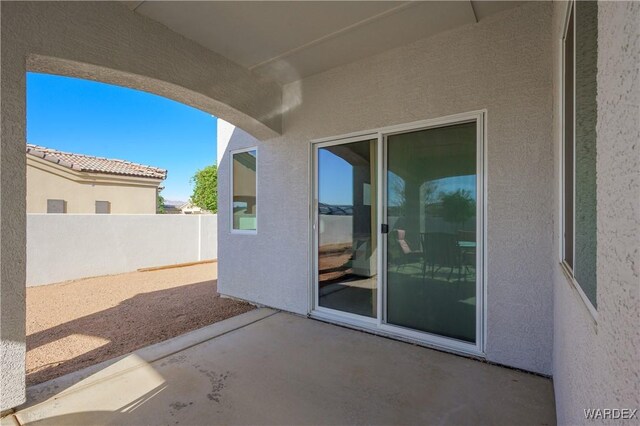 view of patio featuring fence