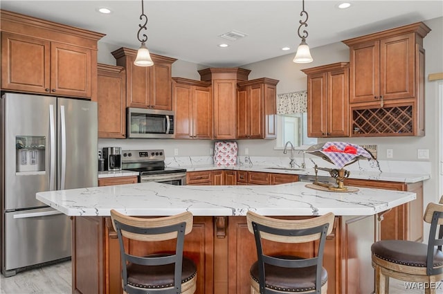 kitchen with recessed lighting, stainless steel appliances, a sink, light stone countertops, and brown cabinetry