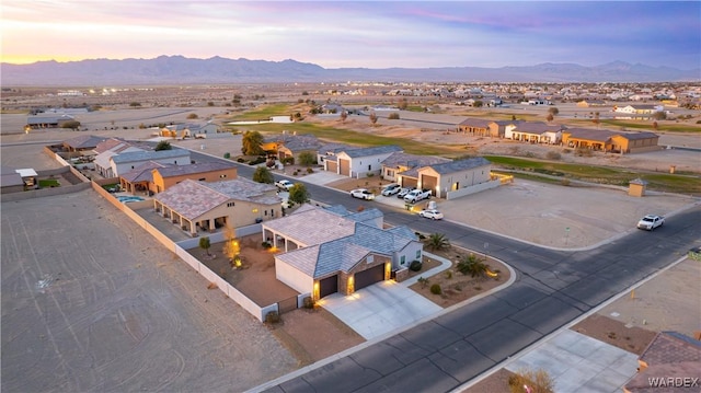 aerial view at dusk with a residential view and a mountain view