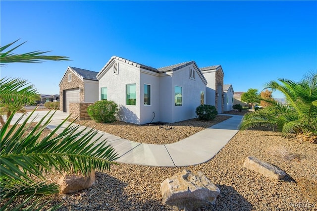 view of home's exterior featuring a garage and stucco siding